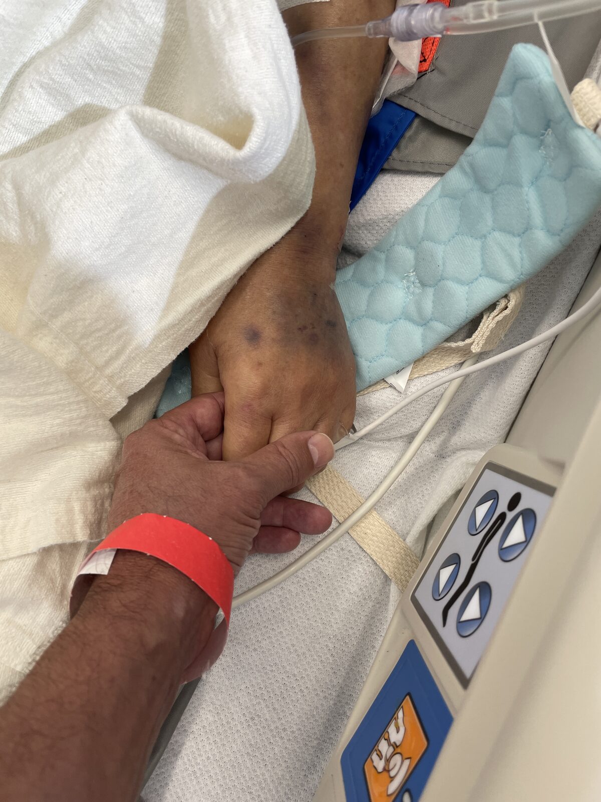 A quiet moment of comfort, hand in hand
