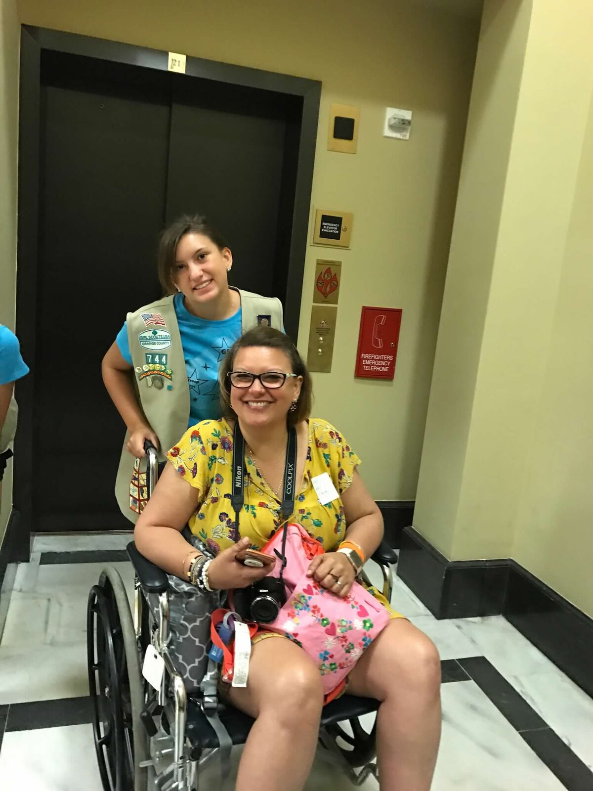 A volunteer helping a patient get where she needs to go